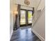 Inviting entryway with stylish wood-look flooring, elegant staircase, and an ornate glass double door at 2689 Muskeg Sw Ct, Atlanta, GA 30331