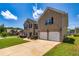 Two-story brick home features a two-car garage, lush green lawn, and a wide driveway for easy parking at 2689 Muskeg Sw Ct, Atlanta, GA 30331