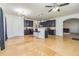 Open kitchen area featuring dark cabinets, granite countertops, stainless steel appliances and travertine floors at 2689 Muskeg Sw Ct, Atlanta, GA 30331