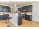 Kitchen with dark cabinets, granite countertops, stainless steel appliances, travertine floors and bar stool seating at 2689 Muskeg Sw Ct, Atlanta, GA 30331