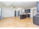 Open kitchen area featuring dark cabinets, granite countertops, stainless steel appliances and travertine floors at 2689 Muskeg Sw Ct, Atlanta, GA 30331