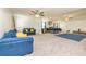 Spacious living room featuring a bed, sofas, ceiling fans, and natural lighting at 2689 Muskeg Sw Ct, Atlanta, GA 30331