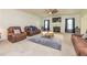 Spacious living room with plush seating, large windows, neutral carpeting, and a cozy fireplace at 2689 Muskeg Sw Ct, Atlanta, GA 30331