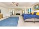Spacious living room featuring a bed, sofas, ceiling fans, and natural lighting at 2689 Muskeg Sw Ct, Atlanta, GA 30331