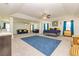 Spacious living room featuring a bed, sofas, ceiling fans, and natural lighting at 2689 Muskeg Sw Ct, Atlanta, GA 30331