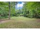 View of spacious backyard surrounded by lush landscaping and mature trees at 2755 Whitehurst Ne Dr, Marietta, GA 30062