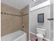 Bathroom featuring a shower-tub combo, a toilet, modern fixtures, and tile at 2755 Whitehurst Ne Dr, Marietta, GA 30062