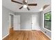 Bedroom with hardwood floors, ceiling fan, neutral paint, window, and closet doors at 2755 Whitehurst Ne Dr, Marietta, GA 30062