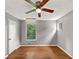 Charming bedroom featuring hardwood floors, a ceiling fan, and a window with a view of greenery at 2755 Whitehurst Ne Dr, Marietta, GA 30062
