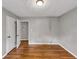 Bright bedroom with hardwood floors, grey walls, closet, and doorway leading to another room at 2755 Whitehurst Ne Dr, Marietta, GA 30062