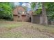 Backyard view of two-story home featuring stairs to deck and screened-in porch at 2755 Whitehurst Ne Dr, Marietta, GA 30062