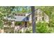 Two-story home with a porch and deck surrounded by lush greenery, offering a serene and private setting at 2755 Whitehurst Ne Dr, Marietta, GA 30062