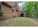 View of backyard and charming home featuring stairs to deck and screened-in porch at 2755 Whitehurst Ne Dr, Marietta, GA 30062