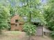 Backyard of home surrounded by lush trees, deck, screened-in porch, and stairs at 2755 Whitehurst Ne Dr, Marietta, GA 30062