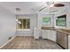 Kitchen featuring tile floor, white cabinets, stainless steel appliances, and natural light from the windows at 2755 Whitehurst Ne Dr, Marietta, GA 30062