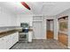 Kitchen with granite countertops, stainless steel appliances, white cabinets, and tile flooring at 2755 Whitehurst Ne Dr, Marietta, GA 30062