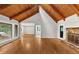 Bright living room with wooden-beamed vaulted ceilings, hardwood floors, fireplace, and large windows showcasing natural light at 2755 Whitehurst Ne Dr, Marietta, GA 30062