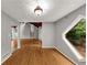 Bright, open-concept room featuring a hardwood floor and a uniquely shaped window with a backyard view at 2755 Whitehurst Ne Dr, Marietta, GA 30062