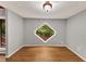 Cozy room featuring a hardwood floor and a unique diamond-shaped window with a view of greenery at 2755 Whitehurst Ne Dr, Marietta, GA 30062