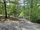 An expansive backyard features a winding walkway to the water through mature landscaping and an abundance of trees at 2831 Bettis Ct, Marietta, GA 30066