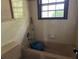 Bathroom view showing bathtub, faucet, window, and tile wall at 2831 Bettis Ct, Marietta, GA 30066