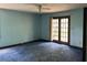 Bedroom with blue carpet and french doors that lead outside at 2831 Bettis Ct, Marietta, GA 30066