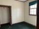 Empty bedroom featuring a window, closet, and unkempt green carpet at 2831 Bettis Ct, Marietta, GA 30066