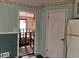 Hallway with view of the staircase and decorative chandelier through the doorway from the kitchen at 2831 Bettis Ct, Marietta, GA 30066