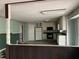 Open kitchen with white cabinets, black appliances, and a checkered floor pattern at 2831 Bettis Ct, Marietta, GA 30066