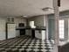 Bright kitchen features white cabinets, black appliances, checkered floors, and access to a patio at 2831 Bettis Ct, Marietta, GA 30066