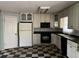 Kitchen features white cabinetry, checkered floors, and a full suite of black appliances at 2831 Bettis Ct, Marietta, GA 30066