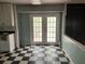 Kitchen featuring checkered floors, white cabinets, with double doors leading to the backyard at 2831 Bettis Ct, Marietta, GA 30066