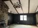 This expansive living room showcases beamed ceilings, stone fireplace, wood paneling, and window views at 2831 Bettis Ct, Marietta, GA 30066