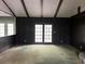 Spacious living room boasting dark wood paneling, beamed ceilings, and French doors to the outdoors at 2831 Bettis Ct, Marietta, GA 30066