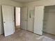 Bedroom with bare floors featuring open doorways and closet space, ready for renovation at 3511 Brookview Dr, Marietta, GA 30068
