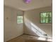 Bright bedroom with bare floors featuring sunlit windows and peeling paint, ready for renovation at 3511 Brookview Dr, Marietta, GA 30068