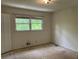 Bright bedroom with bare floors, window, and peeling paint, offering renovation potential at 3511 Brookview Dr, Marietta, GA 30068