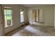 Living room featuring bare walls, plywood floors, windows and doorway at 3511 Brookview Dr, Marietta, GA 30068