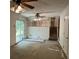 Spacious living room with a ceiling fan and sliding glass doors, ready for renovation at 3511 Brookview Dr, Marietta, GA 30068