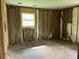 Unfinished bedroom with exposed wall studs, insulation, ready for renovation with a large window at 644 Cambridge Dr, Marietta, GA 30066