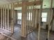 Unfinished bedroom with exposed wall studs, ready for renovation with abundant natural light from the windows at 644 Cambridge Dr, Marietta, GA 30066