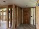 An unfinished entryway with exposed wall studs, ductwork, and a solid wood door ready for renovation at 644 Cambridge Dr, Marietta, GA 30066