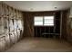 Unfinished room with exposed wall studs, insulation, a window, and visible plumbing ready for renovation at 644 Cambridge Dr, Marietta, GA 30066
