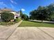 A side-angle of a two story house shows the landscaped side yard and plenty of grass at 311 Arbor Point Sw Ct, Lilburn, GA 30047