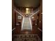 Grand foyer showcasing a staircase with white railings and a decorative rug on the hardwood floor at 311 Arbor Point Sw Ct, Lilburn, GA 30047