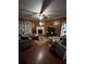 Cozy living room with a fireplace, plush sofas, and dark hardwood floors at 311 Arbor Point Sw Ct, Lilburn, GA 30047