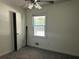 Bedroom with a ceiling fan, closet, window, and gray carpet at 6512 Executive Dr, Winston, GA 30187