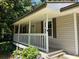 Inviting front porch with white railings and vibrant flowers, creating a warm welcome at 6512 Executive Dr, Winston, GA 30187