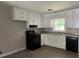 A well-equipped kitchen featuring updated countertops, appliances, and stylish backsplash at 6512 Executive Dr, Winston, GA 30187