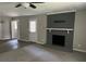 Spacious living room featuring a brick fireplace, ceiling fan, and ample natural light at 6512 Executive Dr, Winston, GA 30187